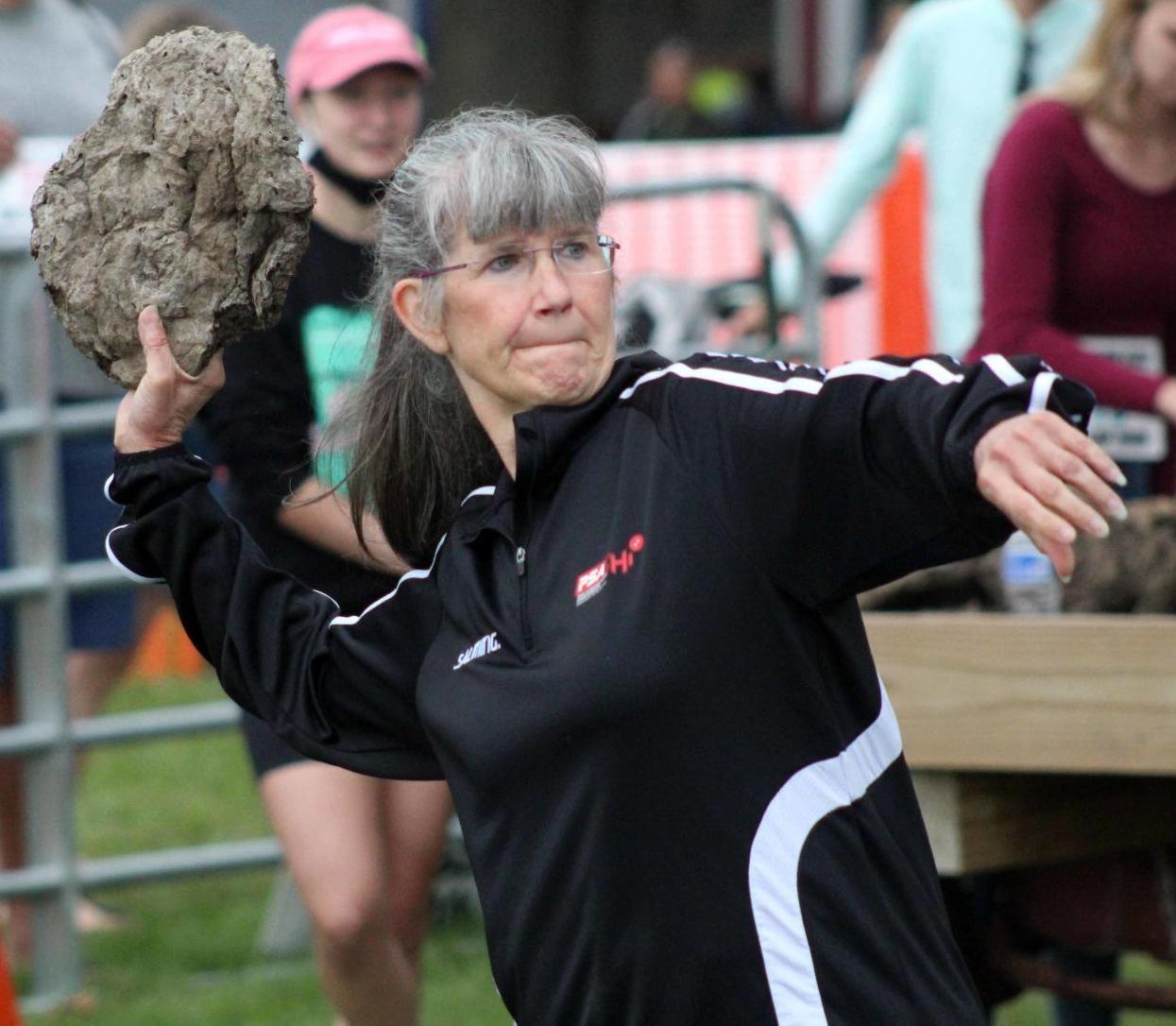 Cheryl throws cow chip